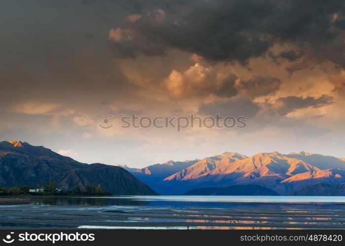 Majestic mountain lake. Beautiful natural landscape of mountain lake and field