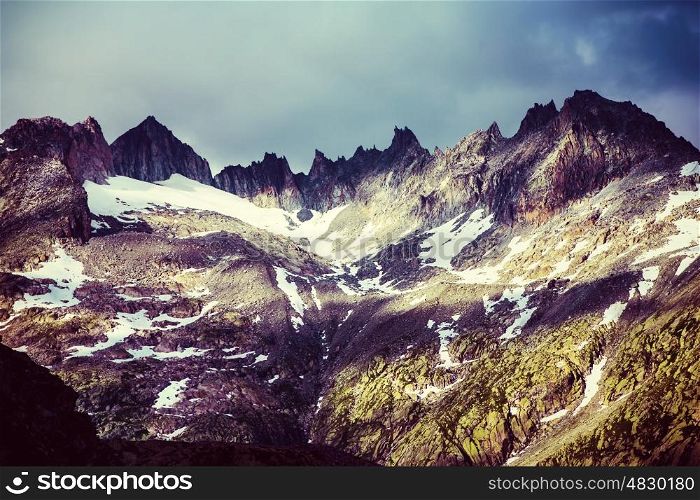Majestic mountainous landscape, beautiful high Alps in summer covering with snow, grunge style photo, beauty of nature concept&#xA;