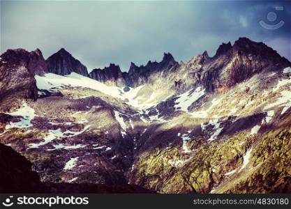 Majestic mountainous landscape, beautiful high Alps in summer covering with snow, grunge style photo, beauty of nature concept&#xA;
