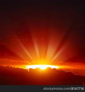 Majestic sunset with bright sunbeams on red dark sky.