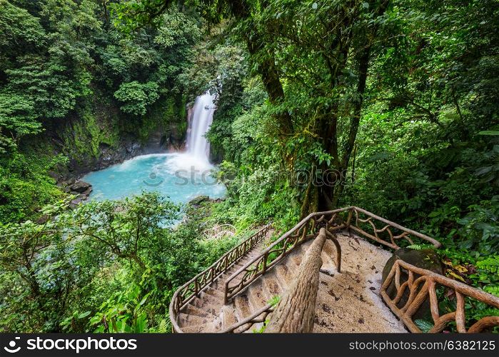 Majestic waterfall in the rainforest jungle of Costa Rica. Tropical hike.