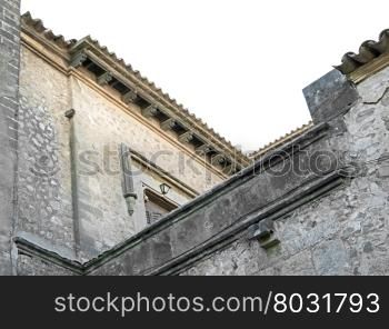 Majorca building materials detail, stone masonry and tiled roof with blue sky in Mallorca, Balearic islands, Spain.