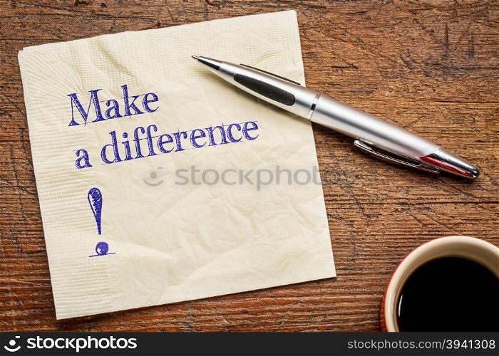 Make a difference! A motivational text on a napkin with a cup of coffee