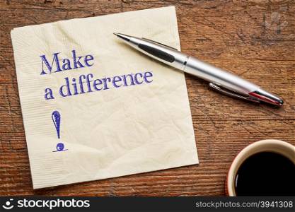 Make a difference! A motivational text on a napkin with a cup of coffee