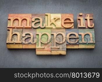 make it happen - inspirational phrase in letterpress wood type printing blocks stained by color inks against slate stone