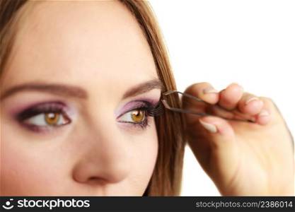 Make up and cosmetics. Woman plucking eyebrows depilating with tweezers. Attractive girl tweezing eyebrows . Woman tweezing eyebrows plucking with tweezers