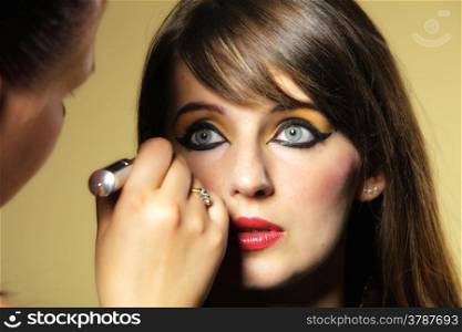 Make up artist applying perfect orient (eastern) makeup to young girl