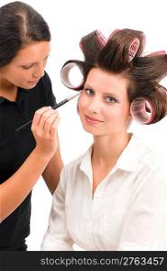 Make-up artist woman fashion model apply eyeshadow with brush