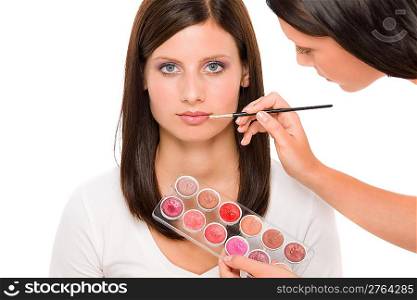 Make-up artist woman fashion model apply lipstick from color palette