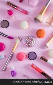 Make up products and macaroons. Make up products and macaroons pattern on pink background