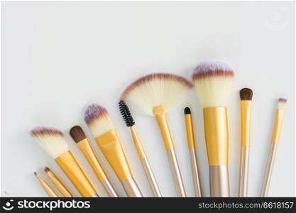 Make up silver and gold brushes close up on white background. Make up brushes