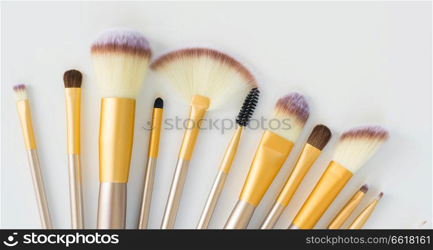 Make up silver and gold brushes close up on white background. Make up brushes