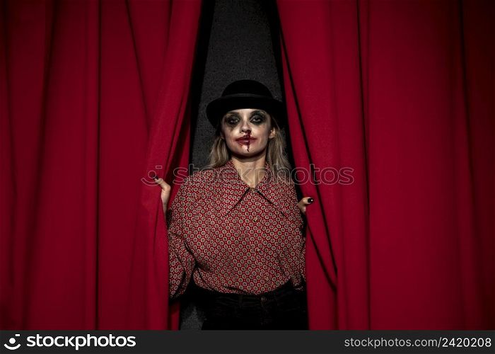 make up woman holding red theatre curtain