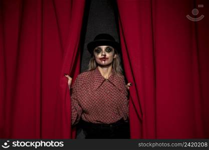 make up woman holding red theatre curtain