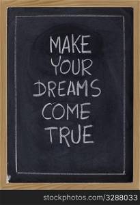 make your dream come true - inspirational phrase on blackboard, white chalk handwriting