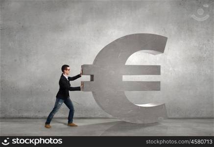 Make your income grow. Young businessman rolling big stone euro sign