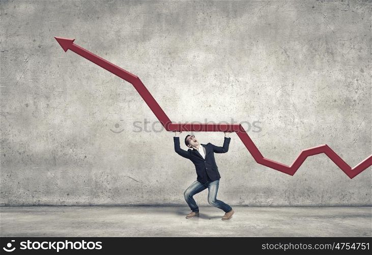 Make your income grow. Young man making effort for red arrow graph grow