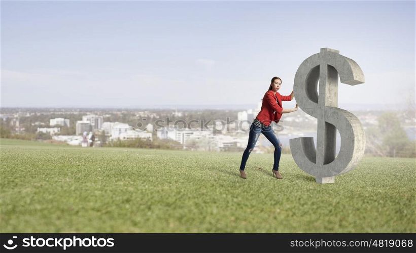 Make your income grow. Young woman in red jacket pushing dollar stone sign