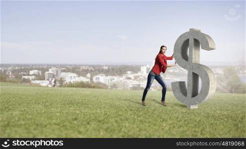 Make your income grow. Young woman in red jacket pushing dollar stone sign