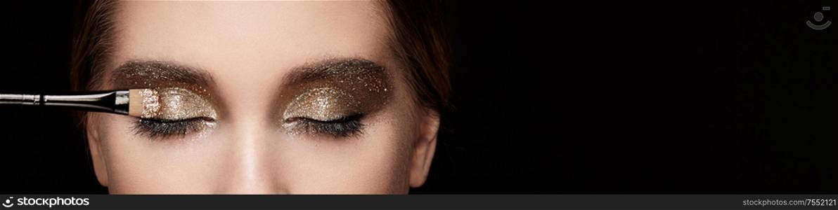 Makeup artist applies eye shadow. Beautiful woman face. Perfect makeup. Lips. Cosmetic Eyeshadow. Make-up detail. Eyeliner