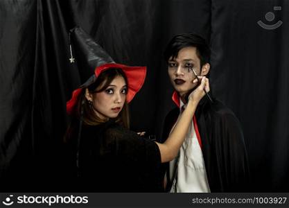 Makeup Artist do Asain teenager makeup for Halloween costume as Vampire prepare for Carnival of Halloween Party