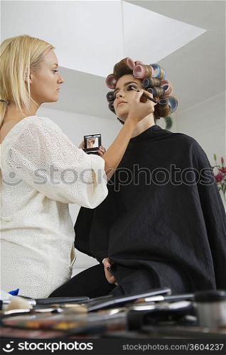 Makeup Artist Preparing Model