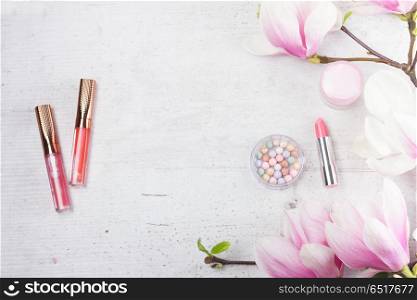 makeup beauty products. Professional makeup beauty products with magnolia flowers, flat lay on white background