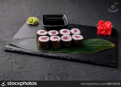 Maki rolls with tuna on black stone