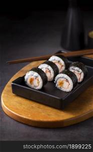 maki sushi rolls with chopsticks. Resolution and high quality beautiful photo. maki sushi rolls with chopsticks. High quality beautiful photo concept