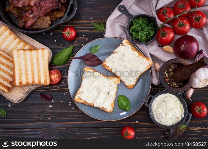 making bacon and cream cheese sandwich - ingredients on wooden table.. making bacon and cream cheese sandwich - ingredients on wooden table