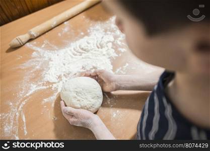 Making bread in a kitchen. Child make bread. Balls of dough