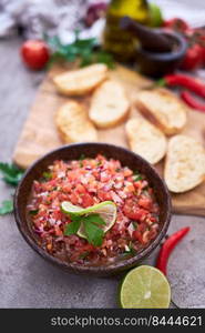 Making bruschetta with freshly made salsa dip sauce.. Making bruschetta with freshly made salsa dip sauce