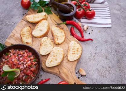 Making bruschetta with freshly made salsa dip sauce.. Making bruschetta with freshly made salsa dip sauce