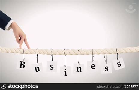 Making business advances. Close up of businessman hands walking with fingers on rope as partnership concept