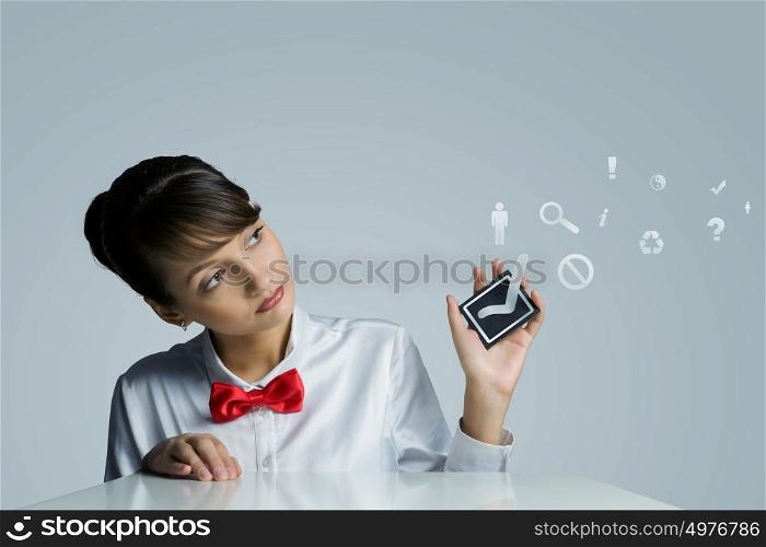 Making choice. Young woman holding black card with tick