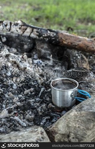 Making coffee on campfire in the forest.