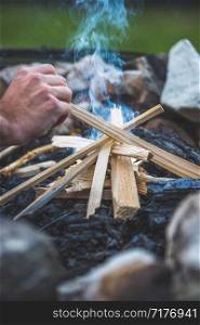 Making fire in the wood, camping outdoors