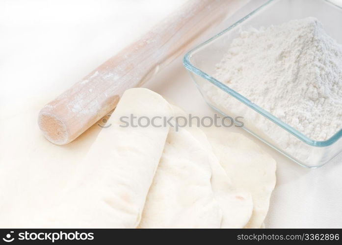 making fresh homemade pita bread ,with ingredients overa table
