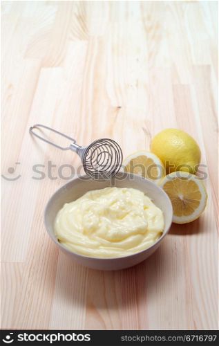 making fresh mayonnaise sauce on kitchen wood table
