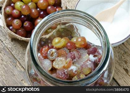 Making grape wine at home from grape fruit and sugar, grapewine is delicious, nutrition, healthy drink, grape after clean, cut in half, embalm with sugar, a alcoholic fermentation to make wine