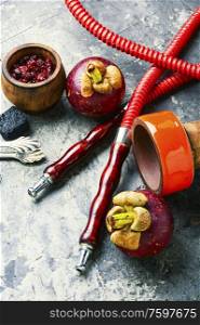 Making hookah with fruit tobacco.Hookah with the aroma of tropical mangosteen fruit.. Mangosteen flavor shisha