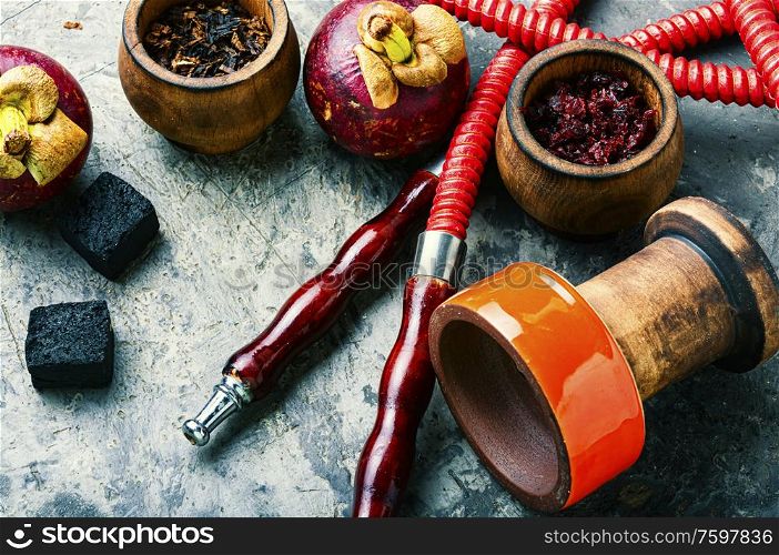 Making hookah with fruit tobacco.Hookah with the aroma of tropical mangosteen fruit.. Mangosteen flavor hookah