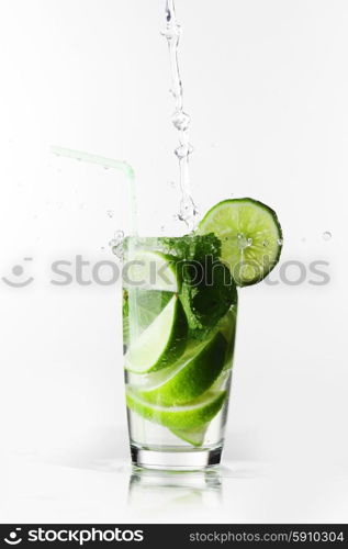 Making mojito cocktail with lime and mint isolated on white background