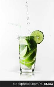 Making mojito cocktail with lime and mint isolated on white background