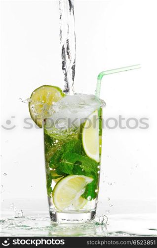 Making mojito cocktail with lime and mint isolated on white background. Making mojito cocktail