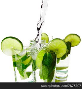 Making mojito cocktails with lime and mint isolated on white background