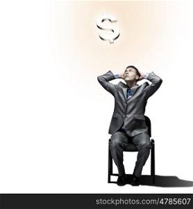 Making money. Successful businessman sitting on chair. Money concept