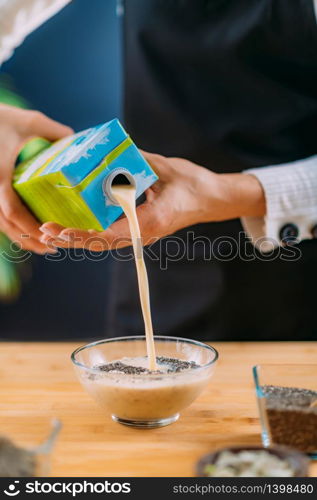 Making Oatmeal with Oats and Soy Milk, Superfood rich in proteins, dietary fibers, minerals and phytonutrients. Making Oatmeal with Oats, Soy Milk and Plant Protein Powder