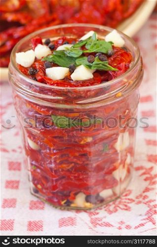 Making of dried tomatoes with garlic, oil and mint