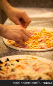 Making Pizza in restaurant, close up hands of chef